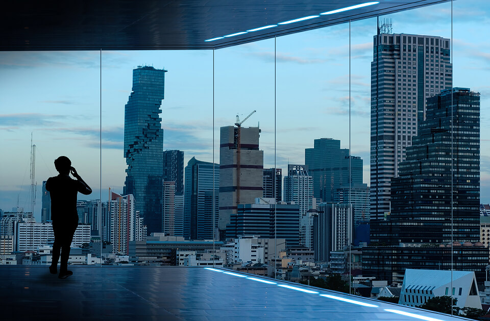 businessman standing using smart-phone modern space watching city night view business ambition