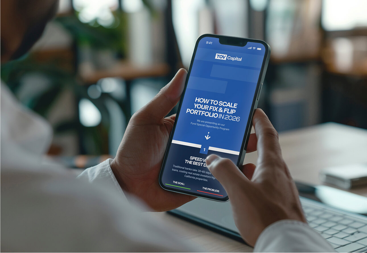 Person holding a phone with TOV capital website